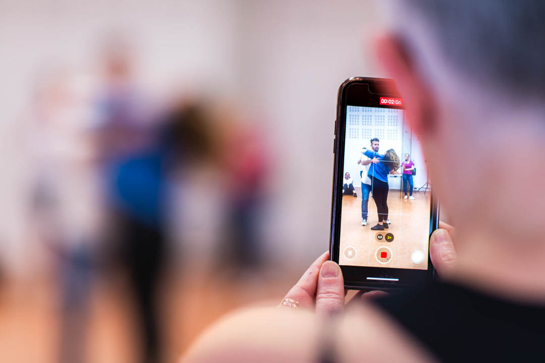 A dance performance framed on a smartphone screen